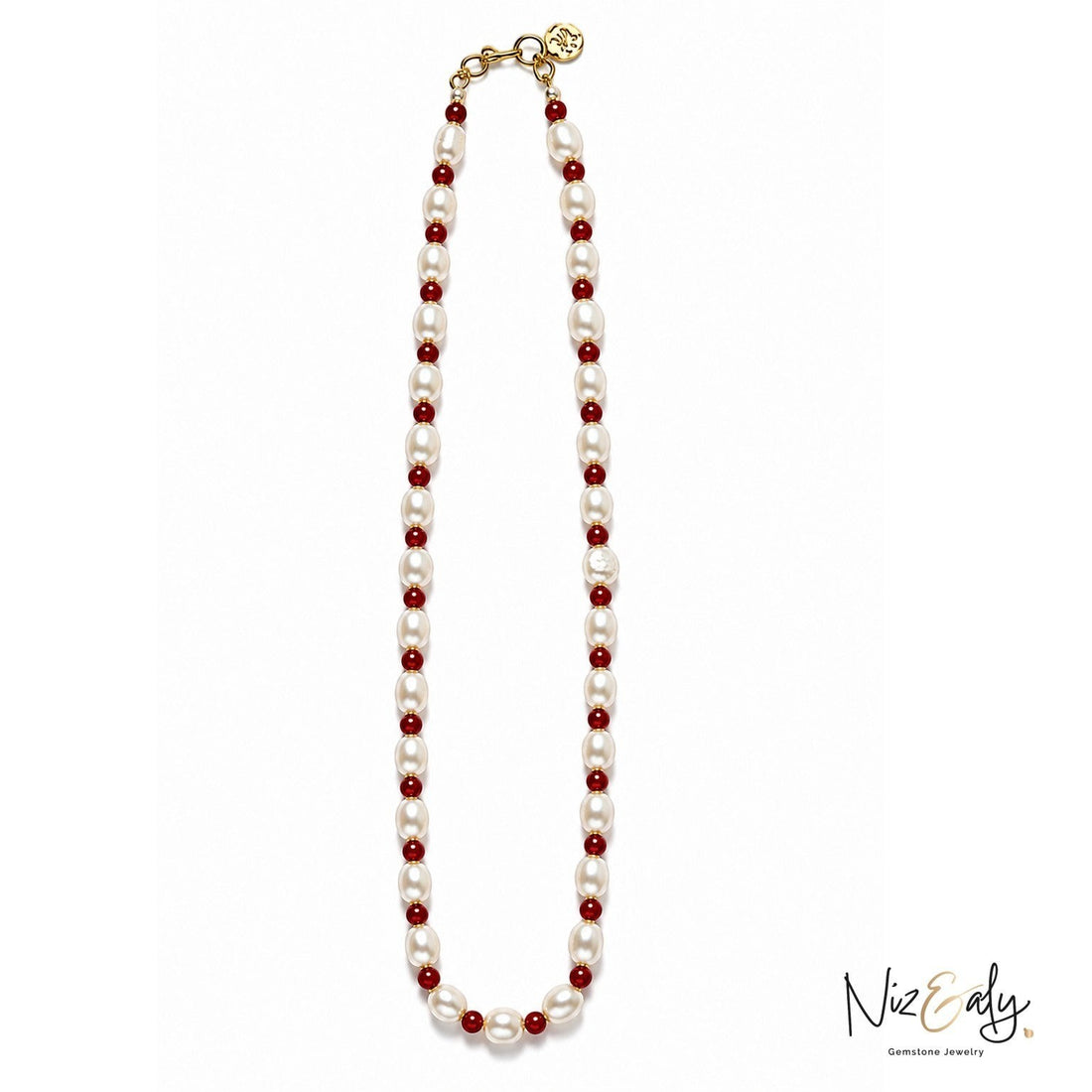 Niz & Aly necklace featuring alternating white freshwater pearls and small red gemstone beads with a gold clasp.
