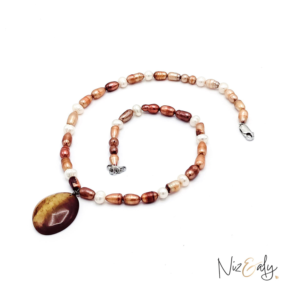 Niz & Aly necklace featuring iridescent freshwater pearls in white and brown with a large tiger eye gemstone pendant.