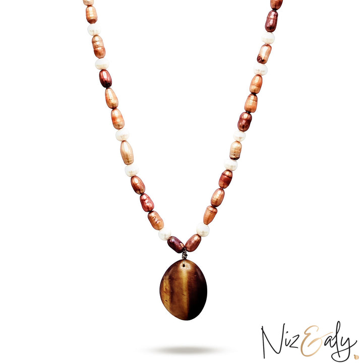 Niz & Aly freshwater pearl necklace featuring a polished oval tiger eye gemstone pendant in brown and white tones.
