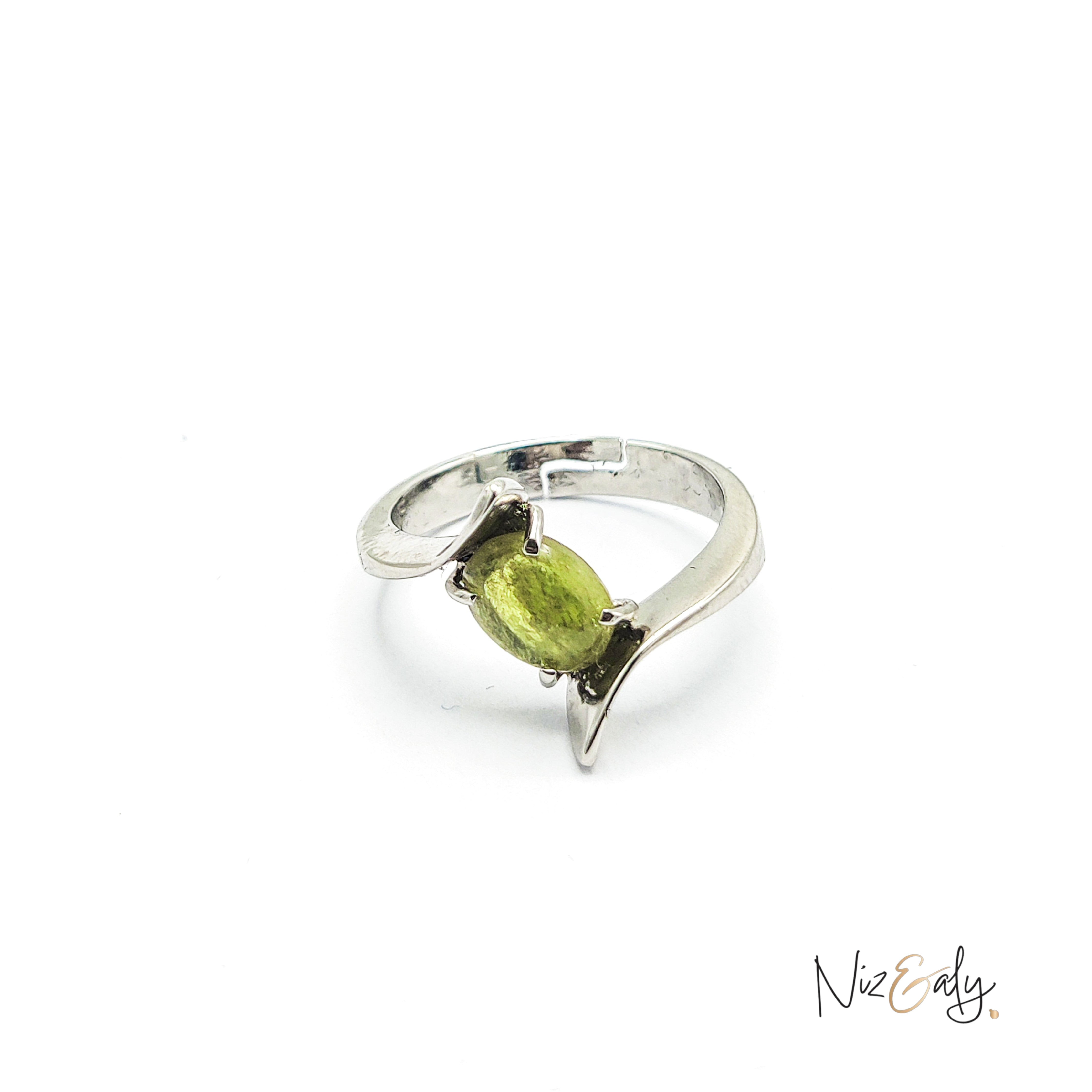 Niz & Aly sterling silver statement ring featuring an oval-cut vibrant green peridot in a modern bypass design.