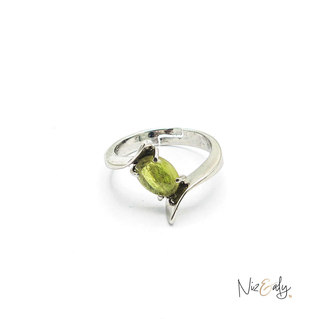 Niz & Aly sterling silver statement ring featuring an oval-cut vibrant green peridot in a modern bypass design.