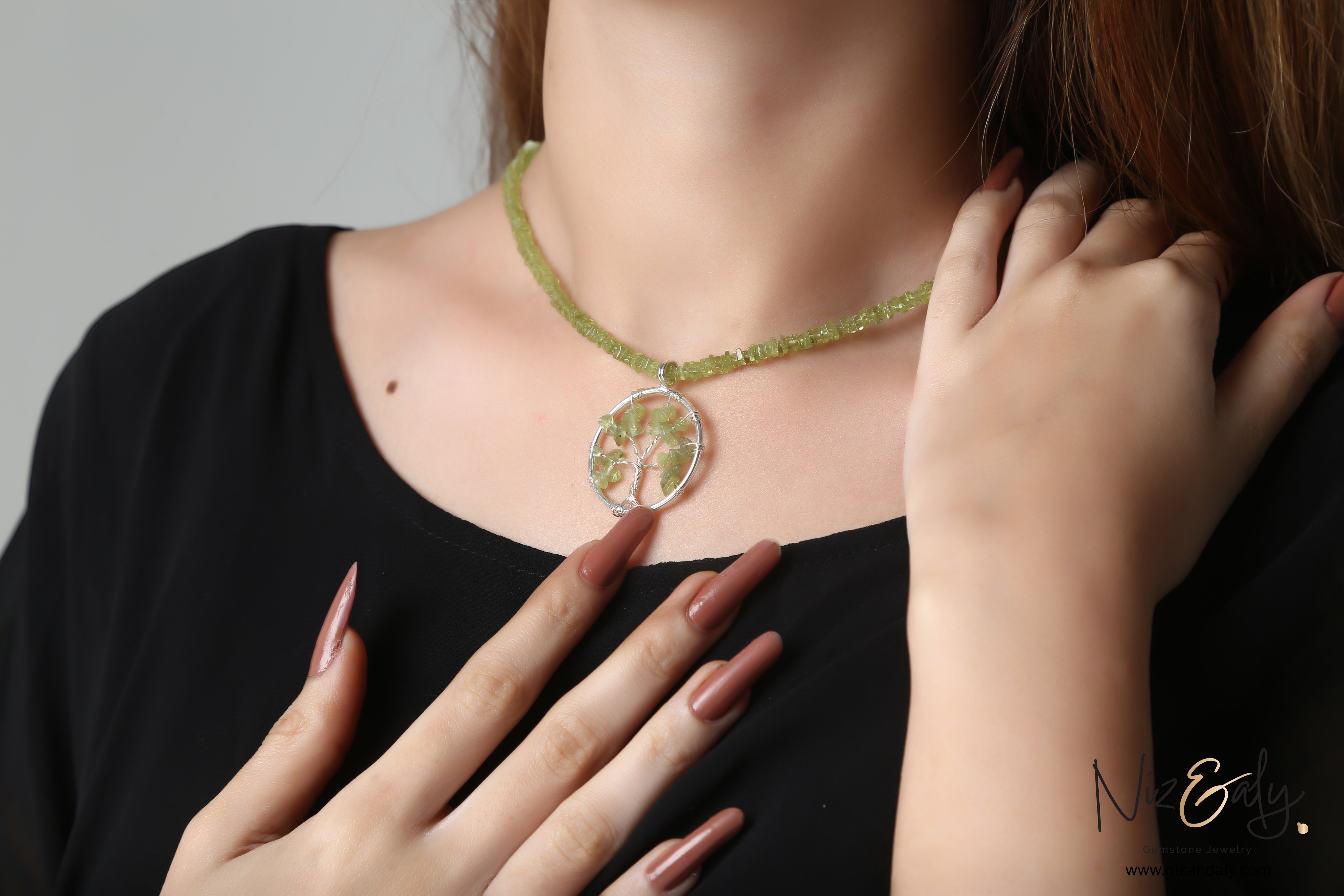 Niz & Aly peridot tree pendant choker necklace with green heishi-cut gemstone beads worn on a model