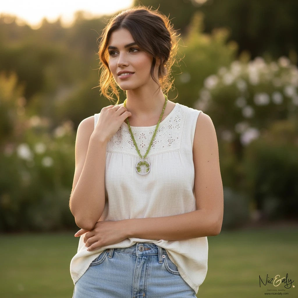 Niz & Aly peridot tree pendant necklace featuring green heishi-cut beads on a woman in a garden setting.