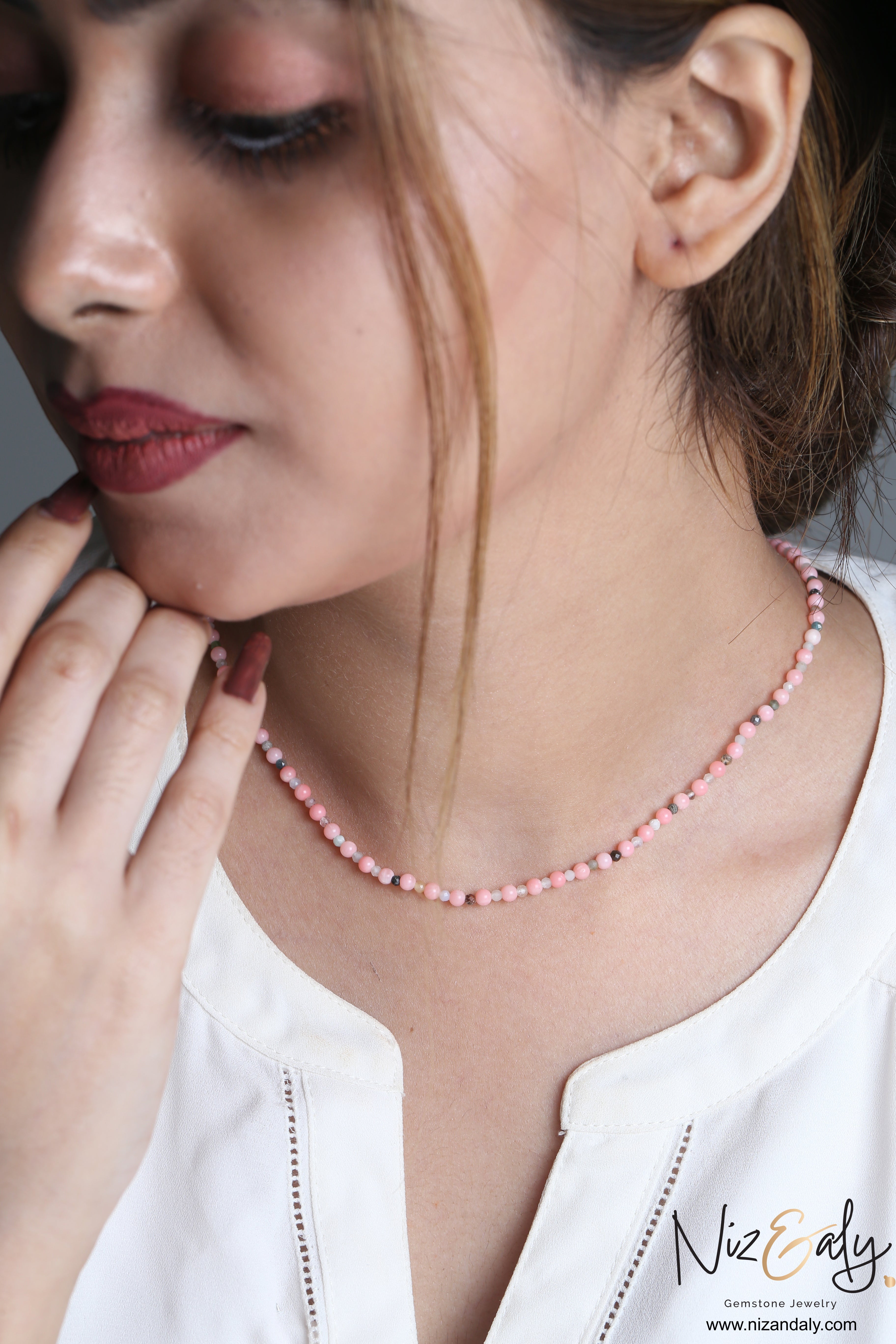 Niz & Aly dainty pink Aragonite bead necklace worn by a woman, featuring soft pastel stones and delicate accents.