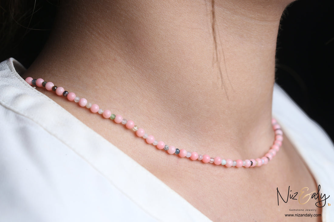 Niz & Aly dainty pink Aragonite bead necklace worn on a woman's neck, featuring soft pastel gemstone beads.
