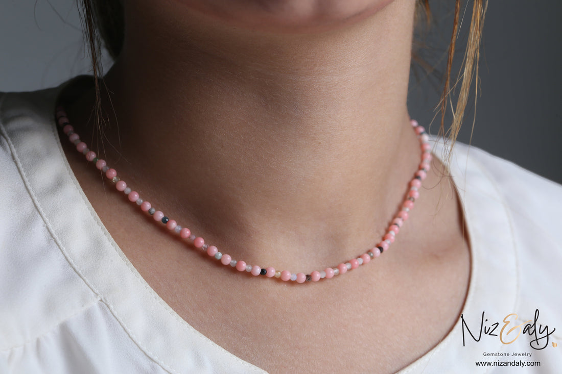 Niz & Aly dainty pink Aragonite bead necklace worn as a choker, featuring soft pastel gemstone beads on a delicate strand.