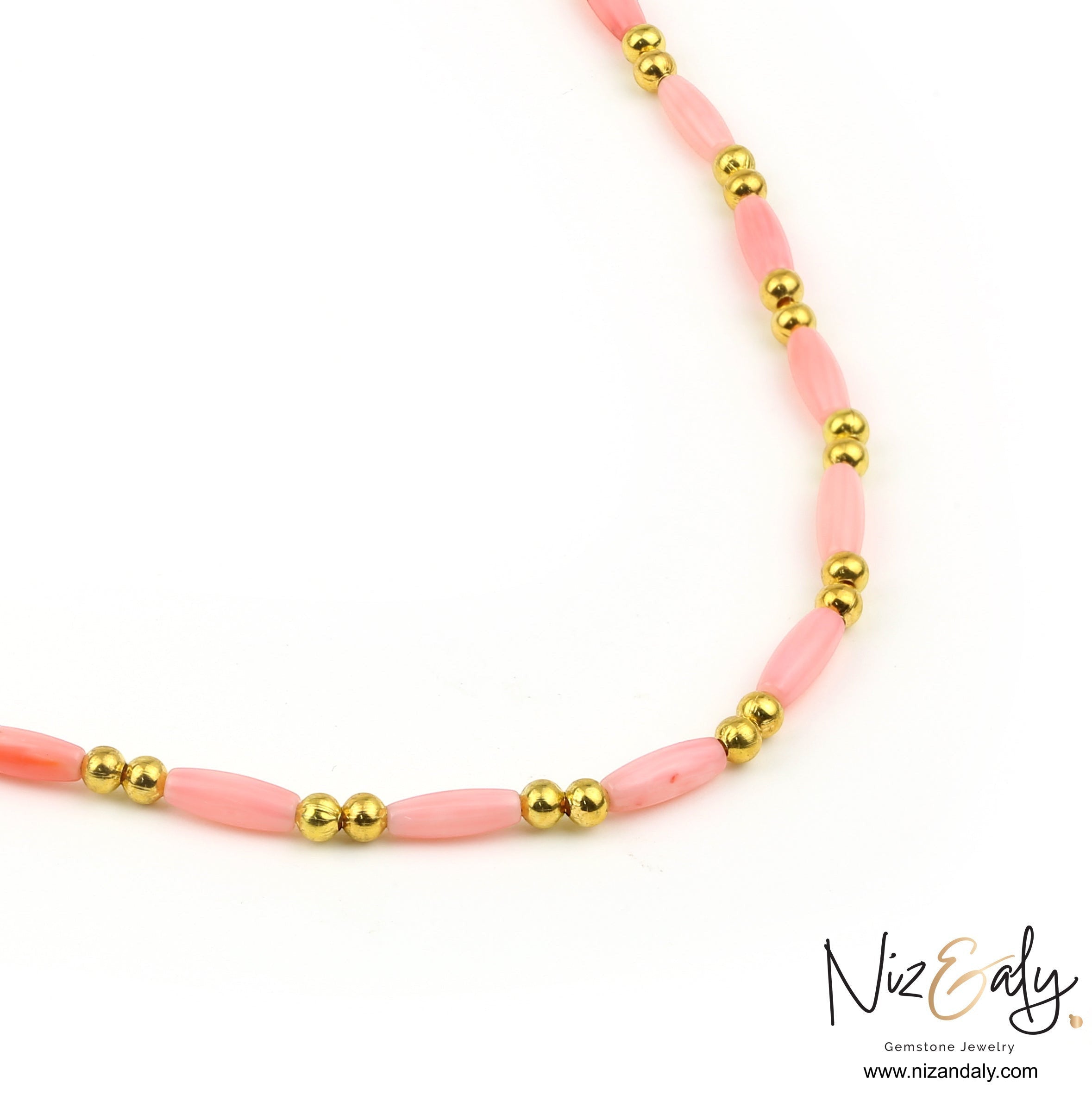 Niz & Aly dainty pink rice-shaped coral necklace with polished gold beads on a white background.