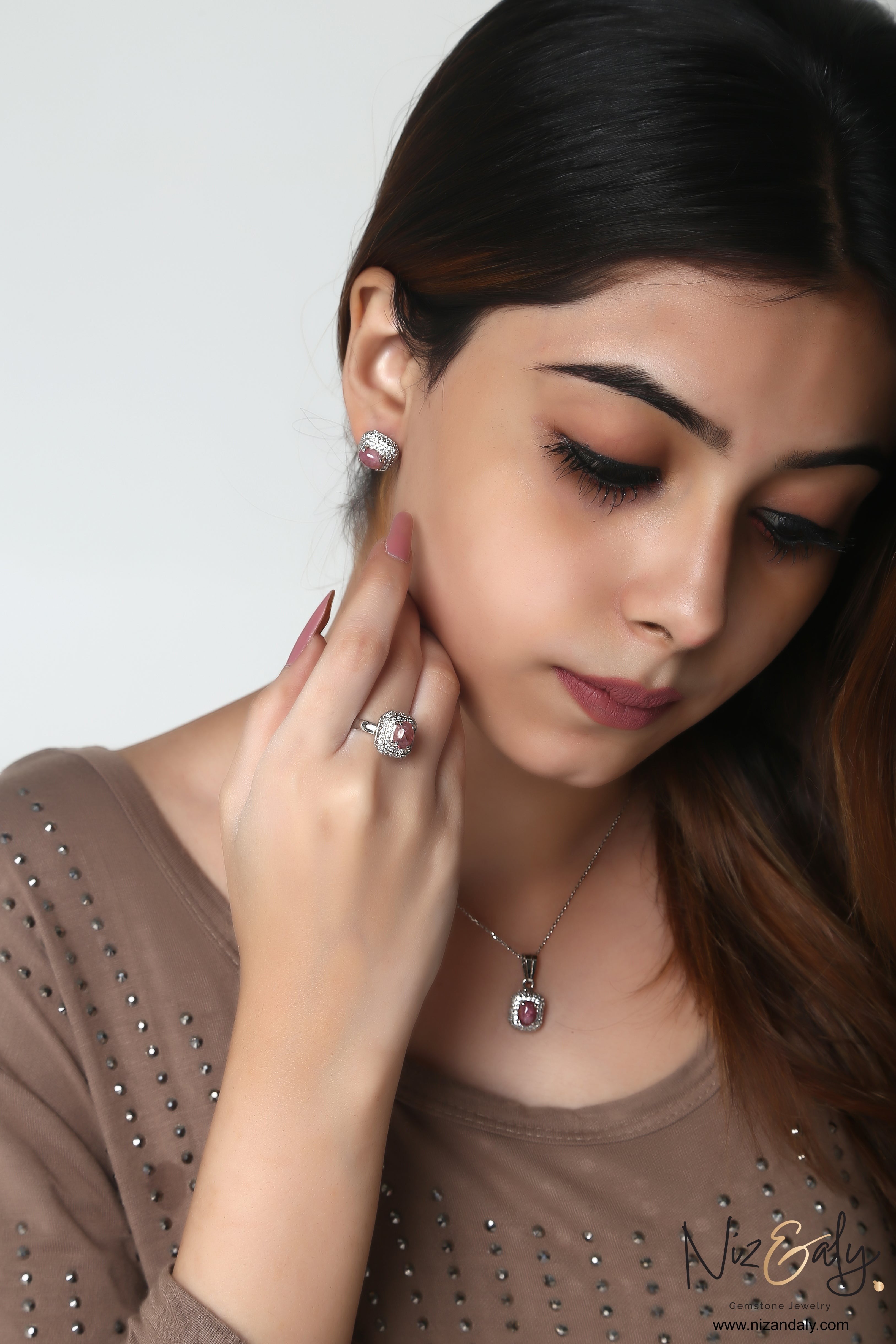 Niz & Aly square pink tourmaline pendant and matching earrings worn by a woman with a silver chain necklace
