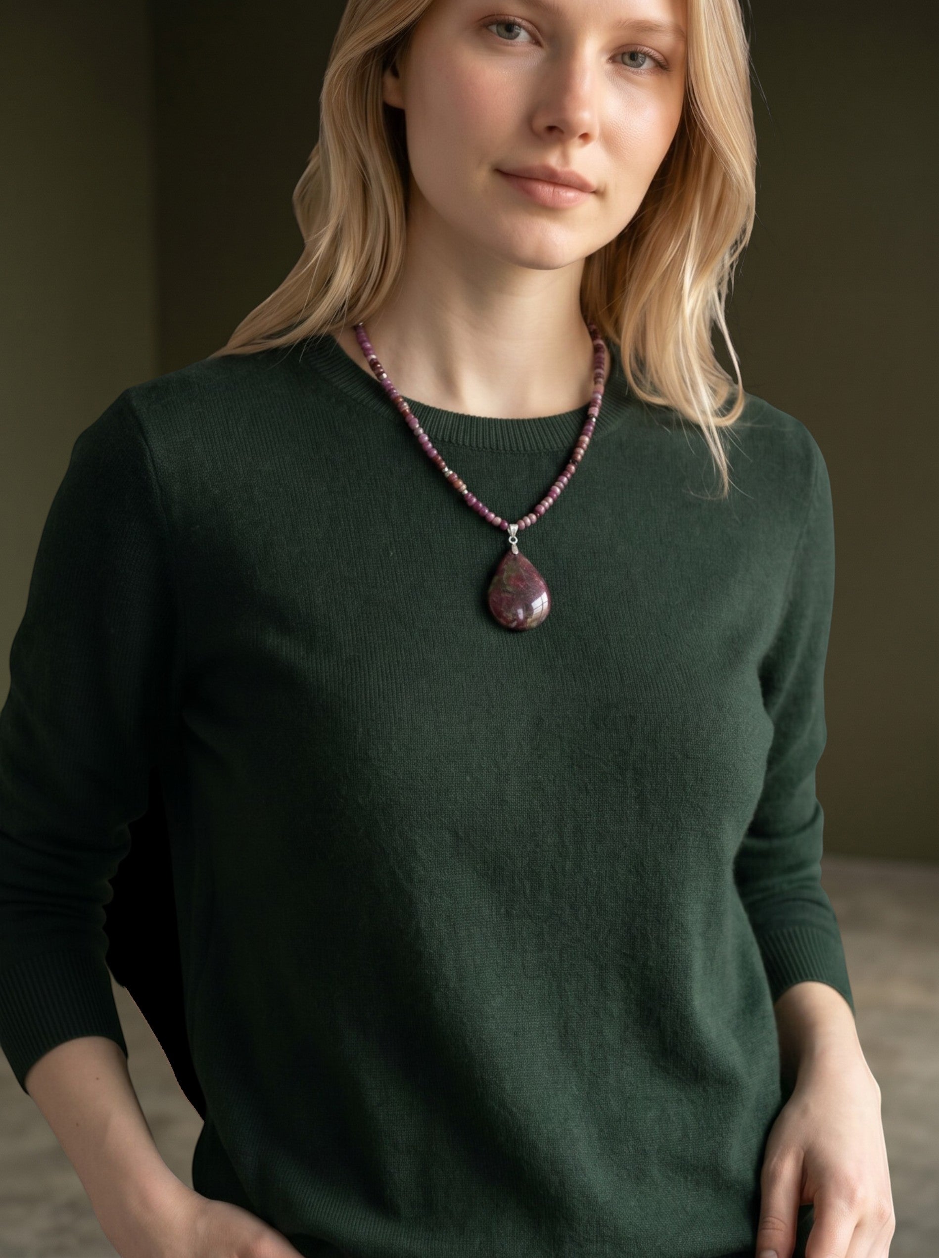 Niz & Aly teardrop purple charoite pendant necklace with lavender and beige beaded chain worn by a woman