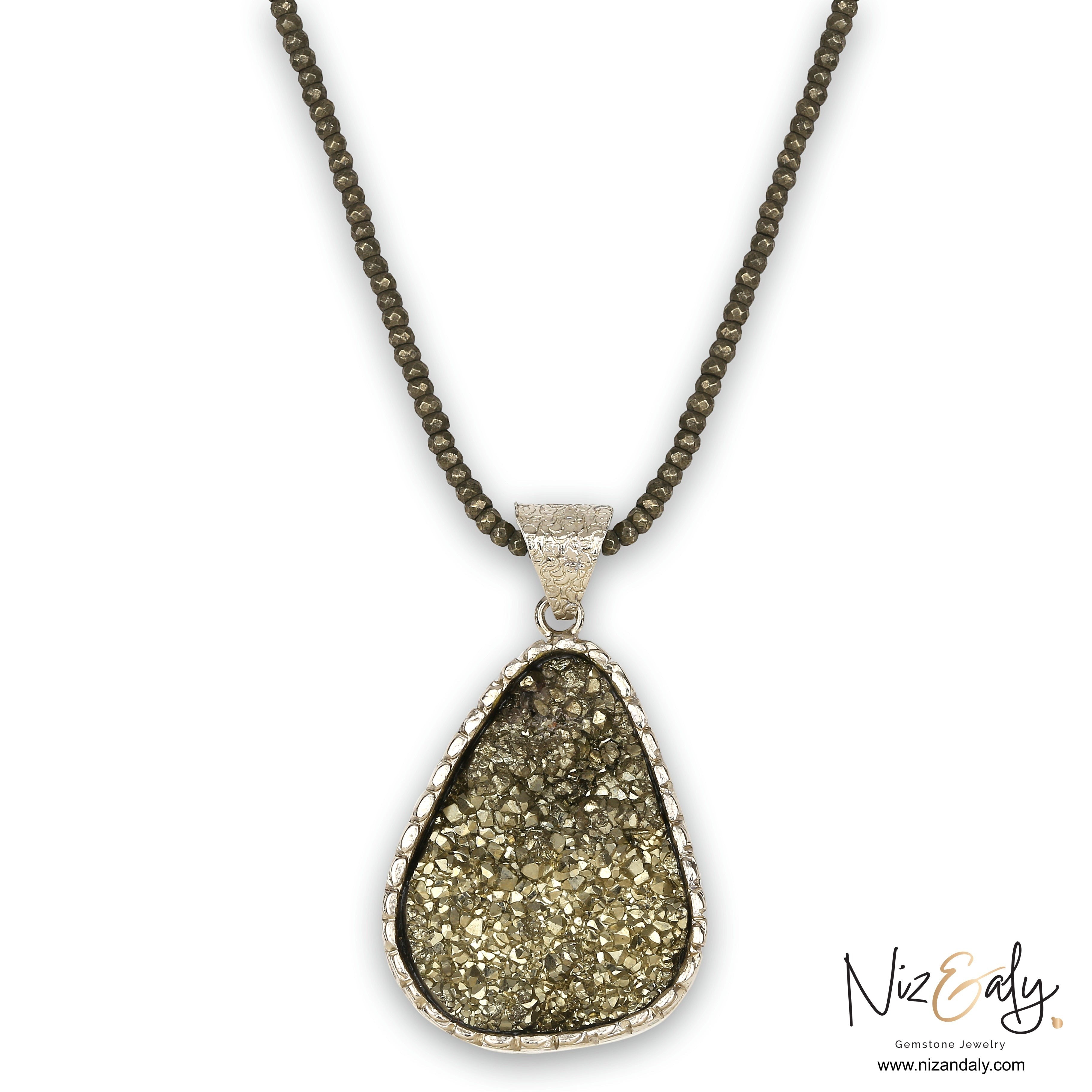 Niz & Aly oval natural pyrite pendant necklace featuring faceted pyrite beads and a textured silver setting.