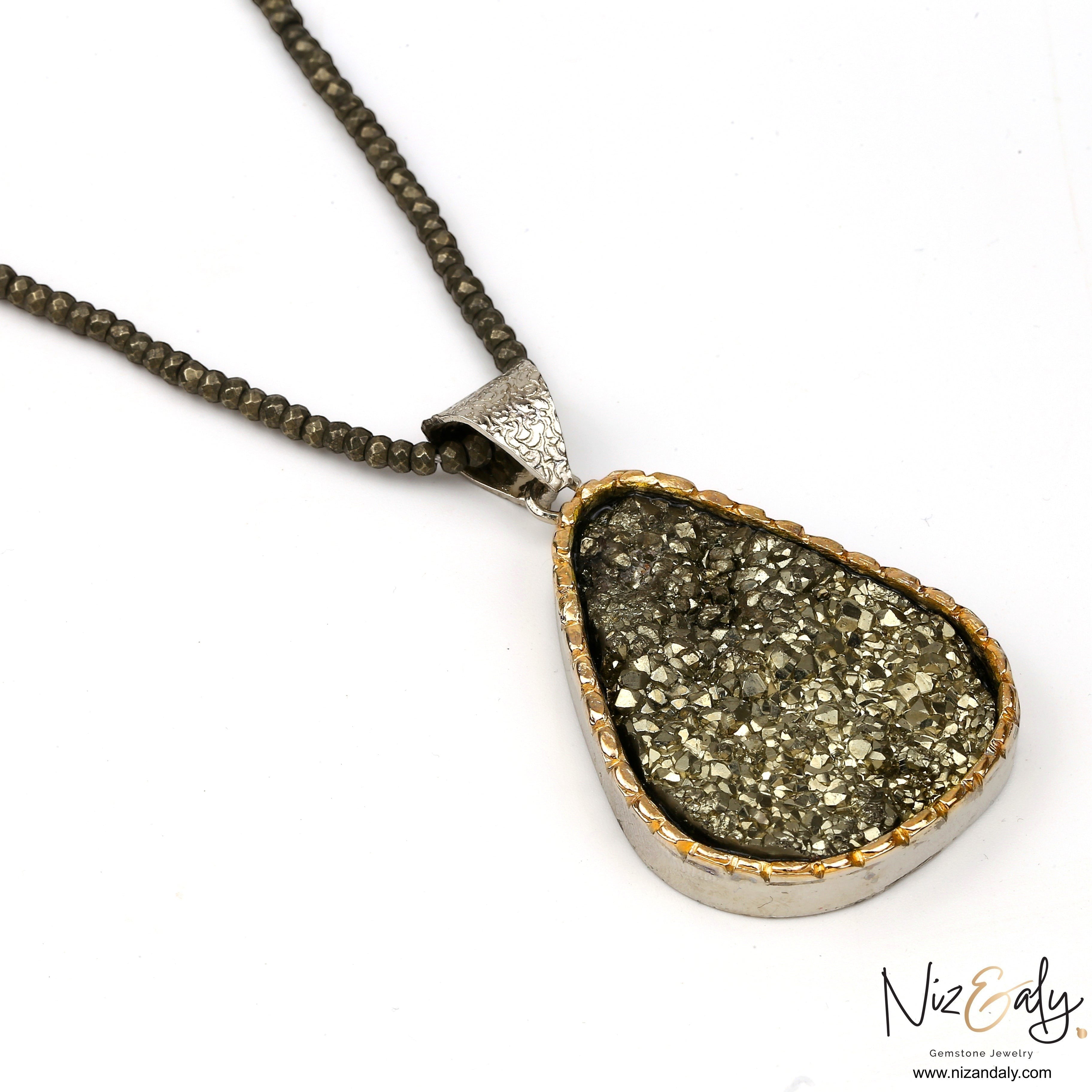 Niz & Aly natural pyrite pendant necklace with faceted pyrite beads and sterling silver setting on a white background