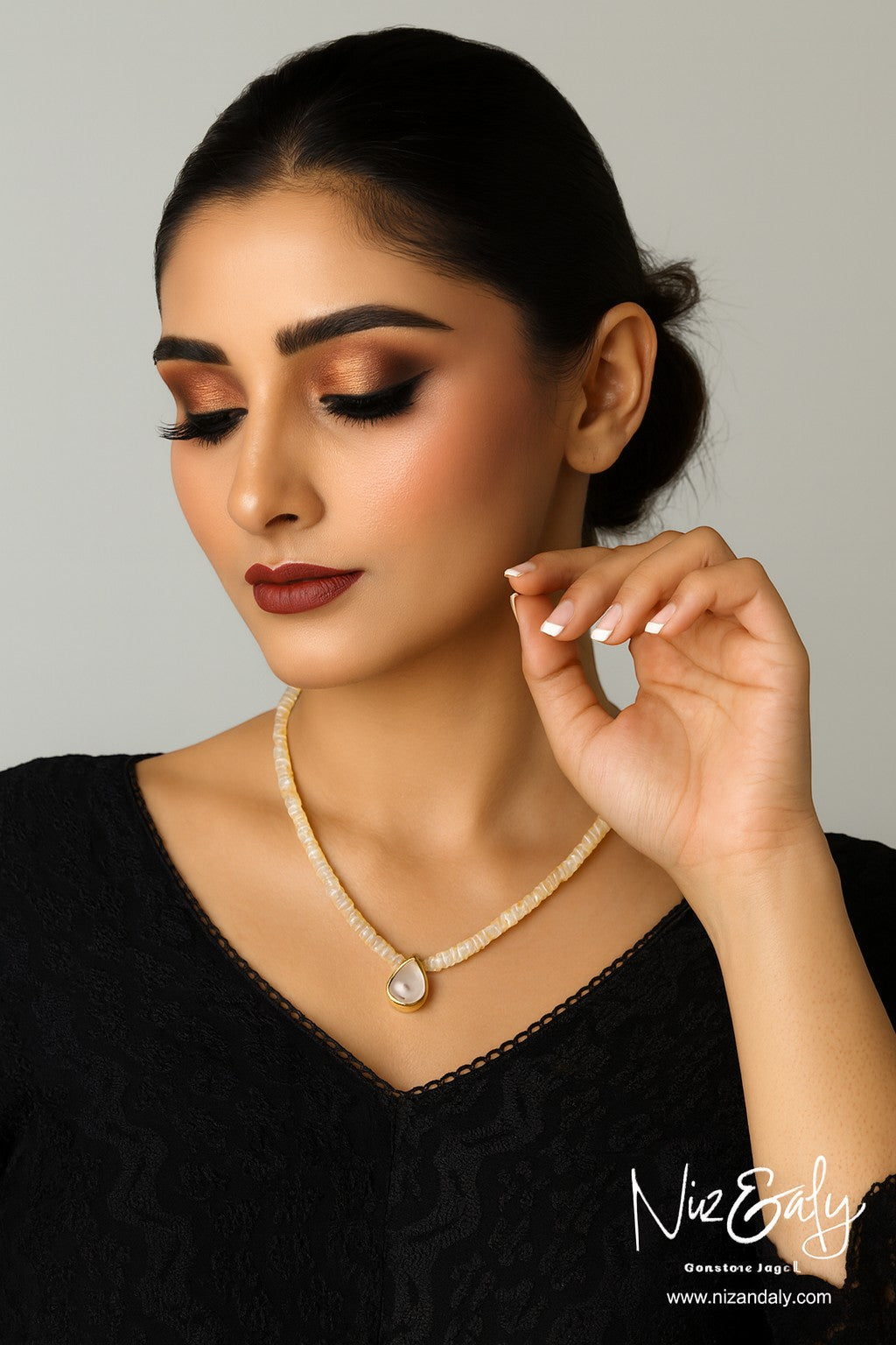 Niz & Aly necklace featuring a teardrop rainbow moonstone pendant on a strand of shimmering Ethiopian fire opal beads.