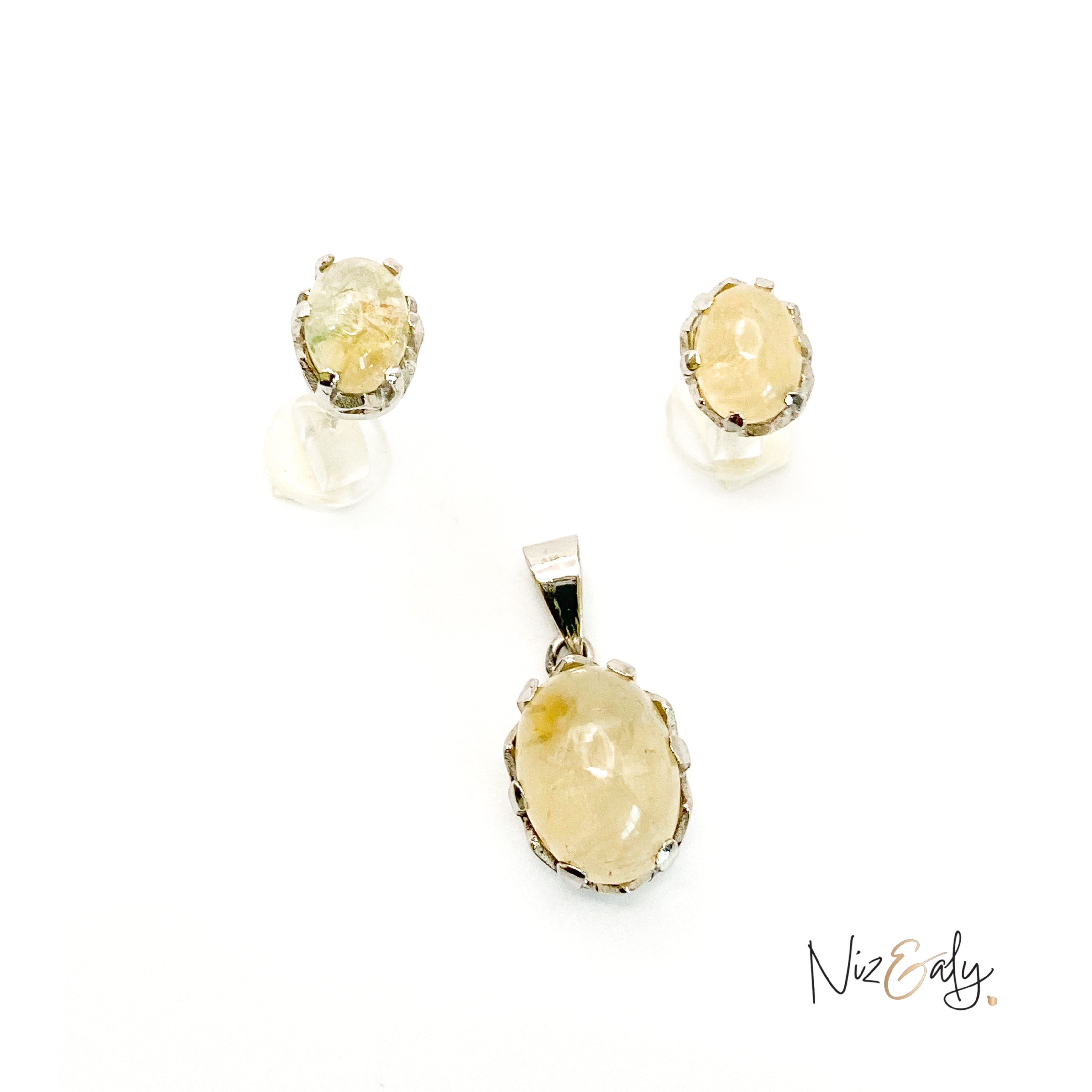 Niz & Aly Raw Citrine Bliss pendant and earring set featuring golden-yellow raw citrine stones in silver settings.