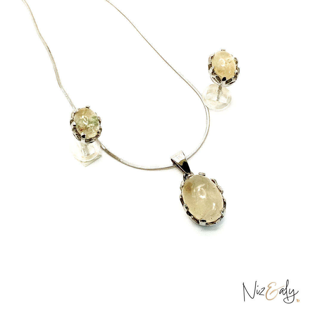 Niz & Aly Raw Citrine Bliss pendant and earring set featuring golden-yellow raw stones in silver settings.