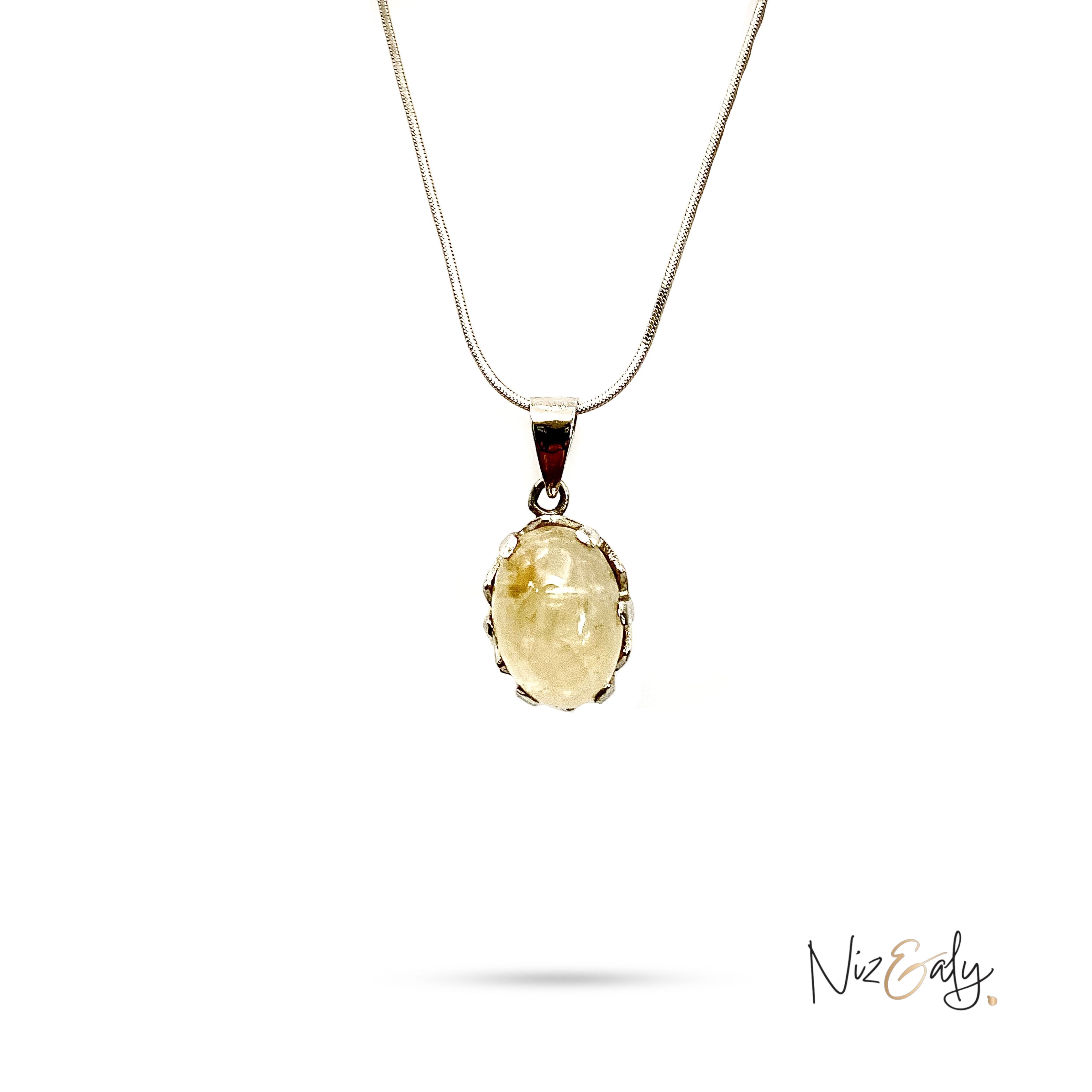 Niz & Aly Raw Citrine Bliss pendant featuring a golden-yellow oval stone in a silver setting on a delicate chain