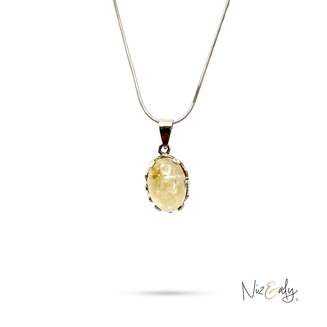 Niz & Aly Raw Citrine Bliss pendant featuring a golden-yellow oval stone in a silver setting on a delicate chain
