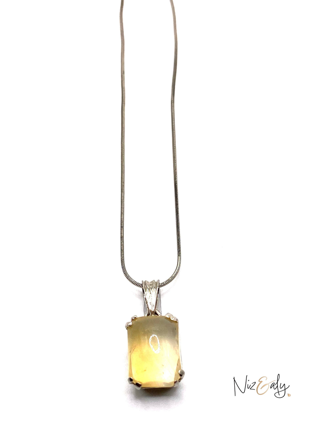 Niz & Aly raw citrine pendant necklace featuring a golden yellow gemstone on a delicate silver chain