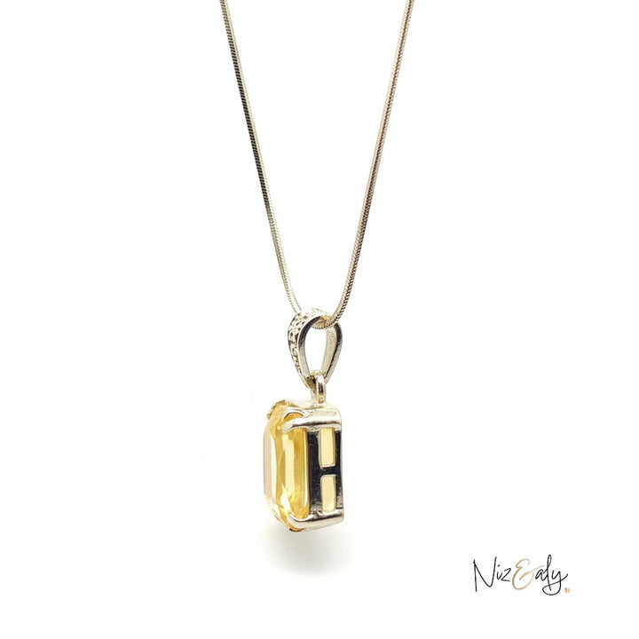 Niz & Aly raw citrine pendant necklace featuring a golden gemstone in a silver setting on a delicate chain