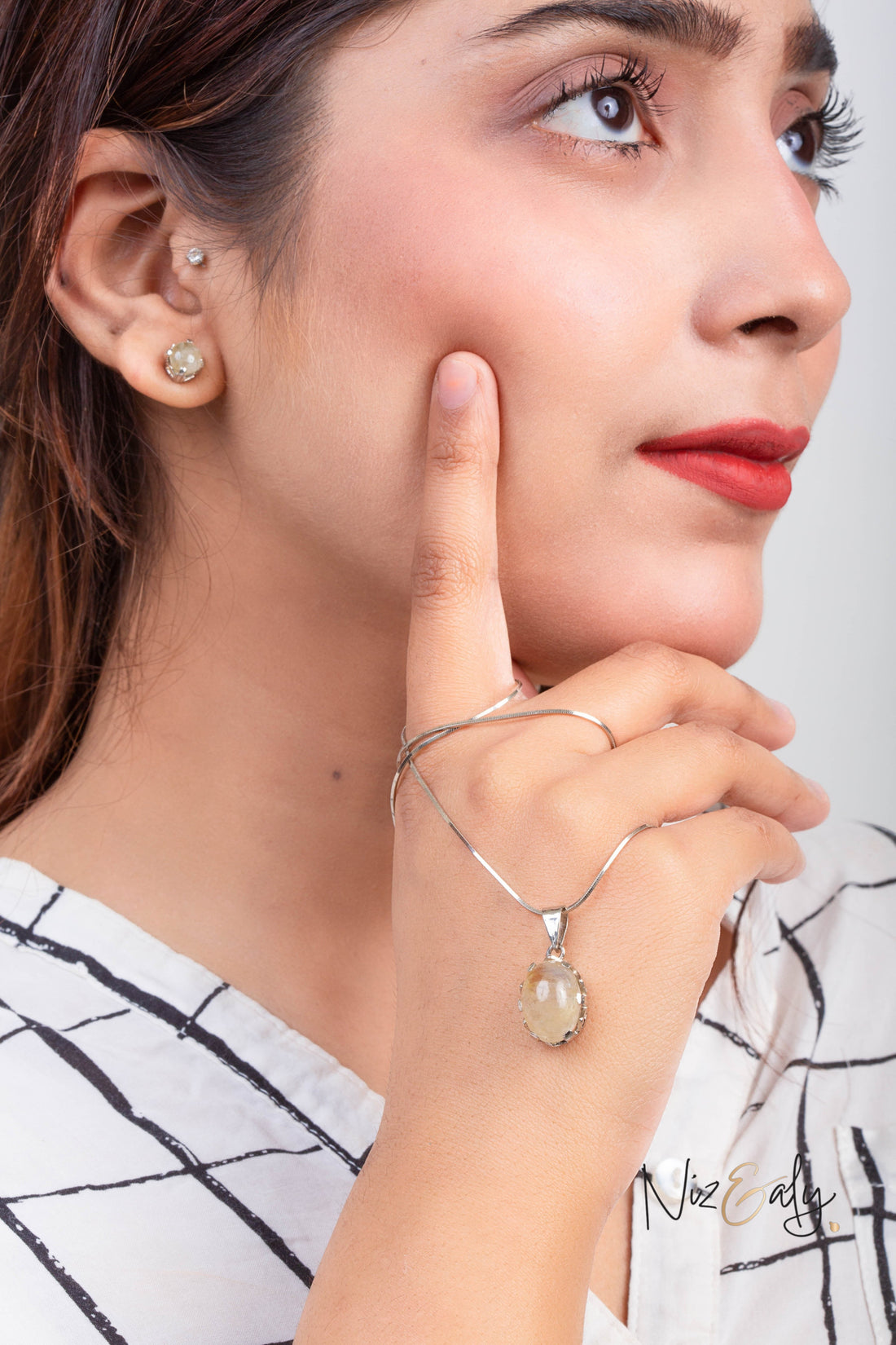 Niz & Aly Raw Citrine Bliss pendant and earring set worn by a woman, featuring golden-yellow raw citrine in silver.