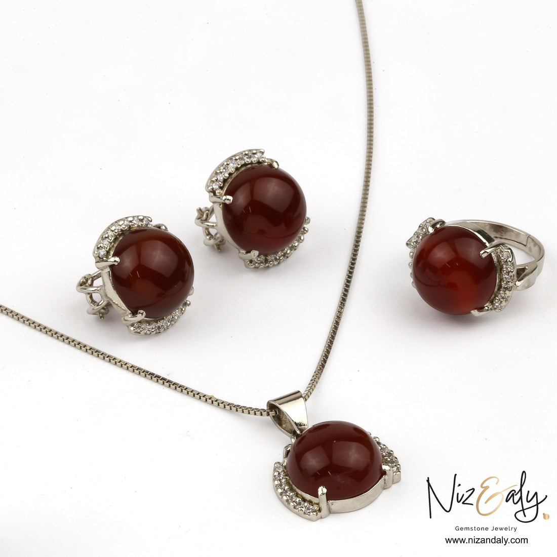 Niz & Aly red agate pendant, ring, and earring set with silver-tone metal and sparkling crystal accents.