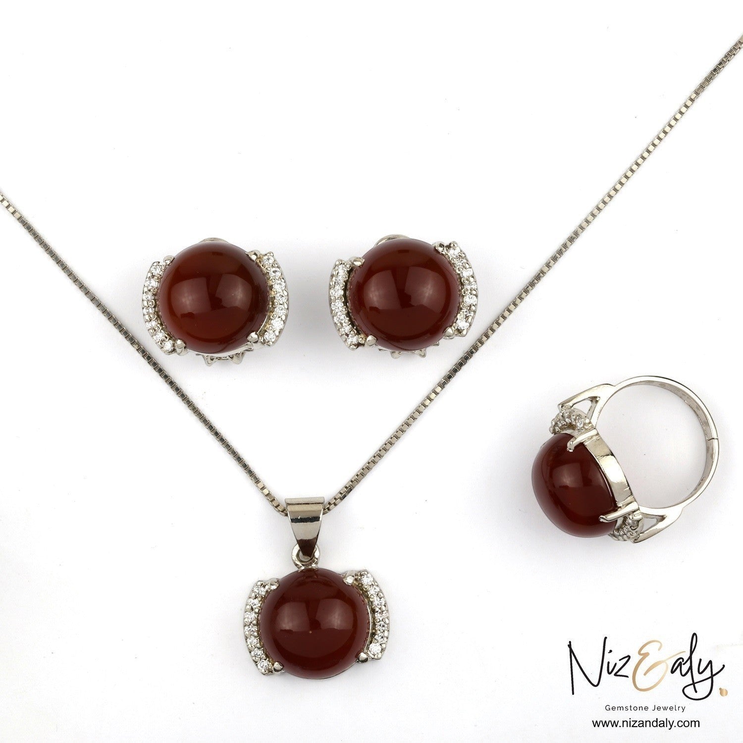 Niz & Aly red agate pendant, earrings, and ring set with polished gemstones and sparkling crystal accents.