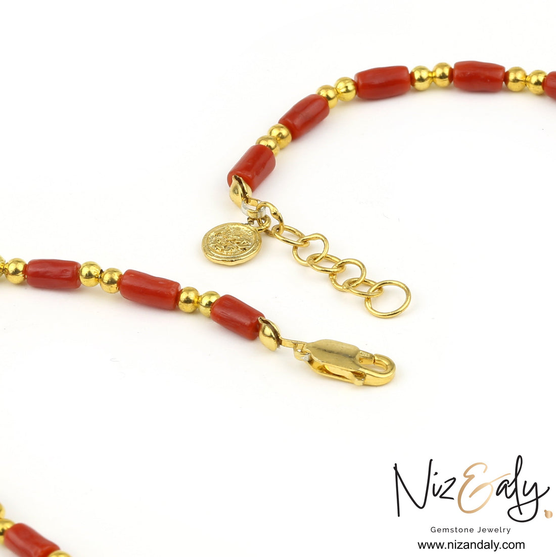 Niz & Aly natural red coral barrel bead necklace with polished gold round spacers and a gold coin charm clasp.