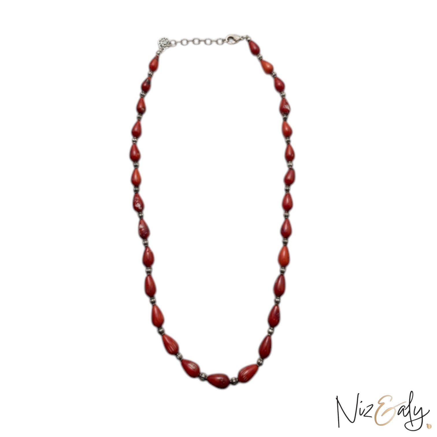 Niz & Aly Rossa Lacrima necklace featuring natural red coral teardrop beads on a delicate silver chain.