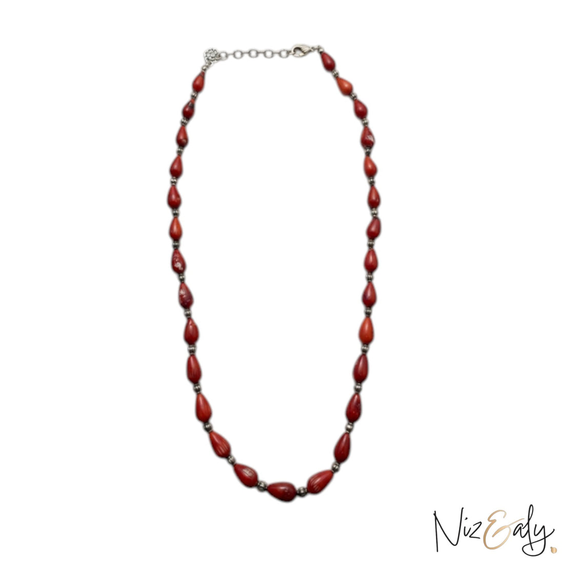 Niz & Aly Rossa Lacrima necklace featuring natural red coral teardrop beads on a delicate silver chain.