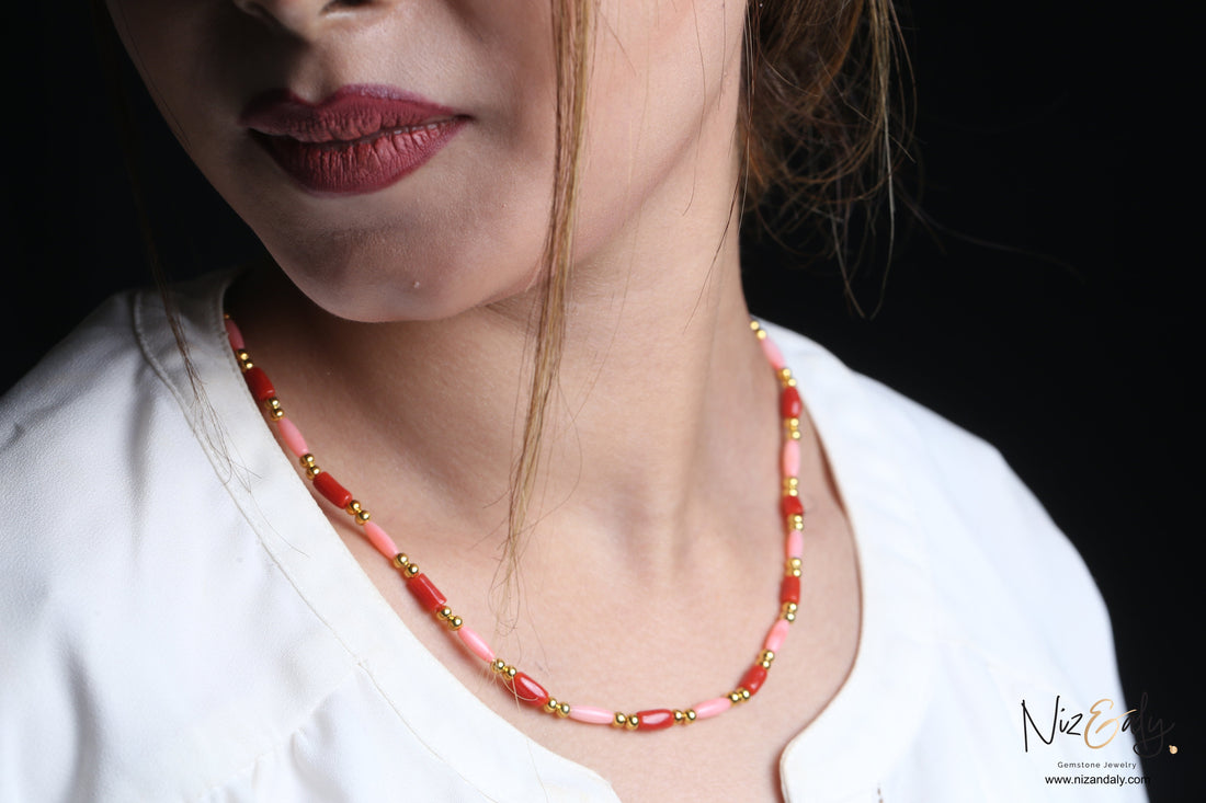 Niz & Aly dainty necklace featuring red and pink rice-shaped coral beads accented with small polished gold spheres