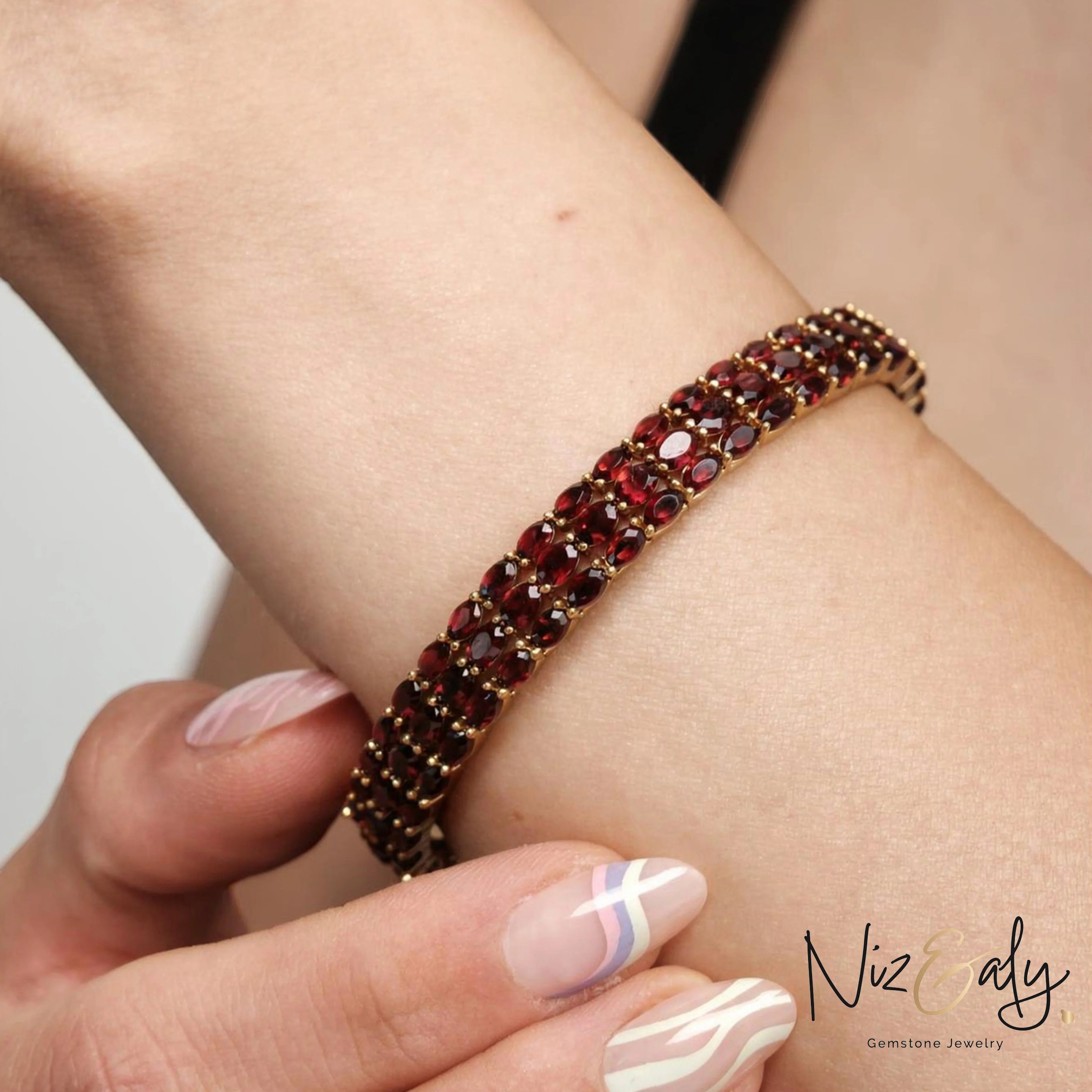 Niz & Aly multi-row rhodolite garnet bracelet featuring marquise-cut red stones set in 14K gold-plated sterling silver.