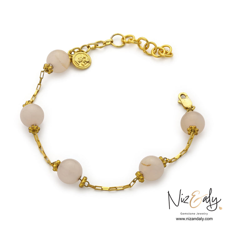 Niz & Aly rose quartz bracelet featuring round pink gemstones on a gold-plated 925 sterling silver chain