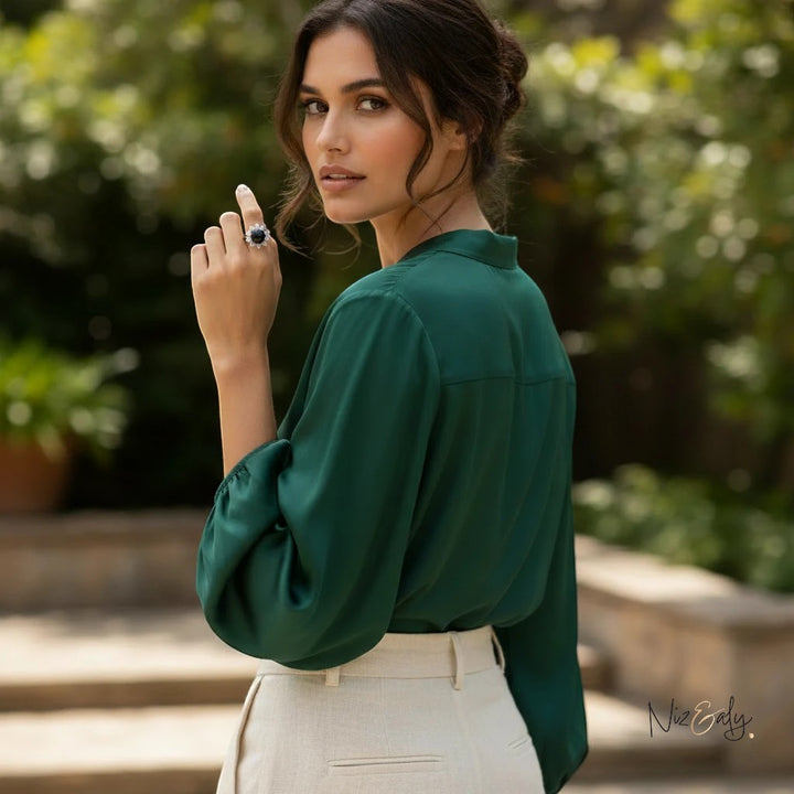 Niz & Aly round black onyx statement ring worn by a woman in a green blouse, showcasing polished gemstone jewelry.
