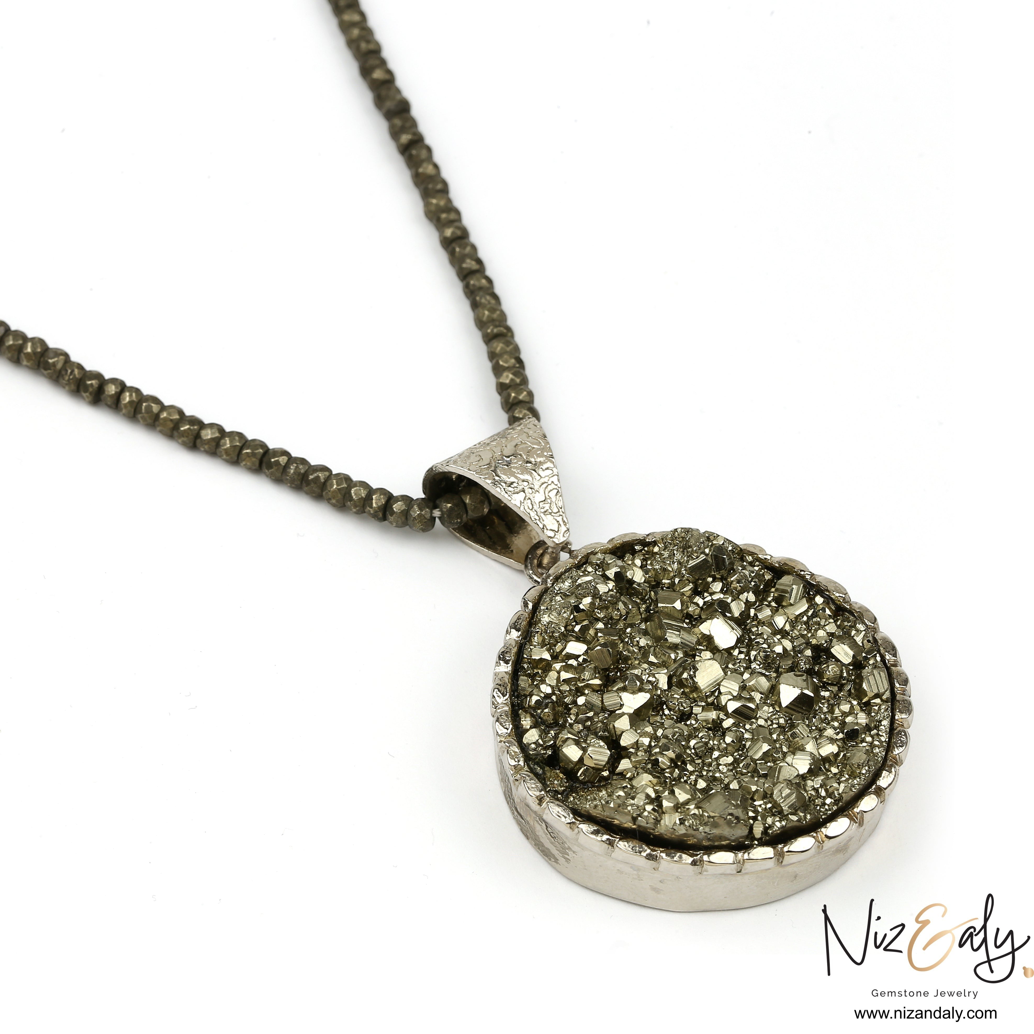 Niz & Aly round pyrite pendant necklace featuring a textured metallic gemstone on a faceted pyrite bead chain.