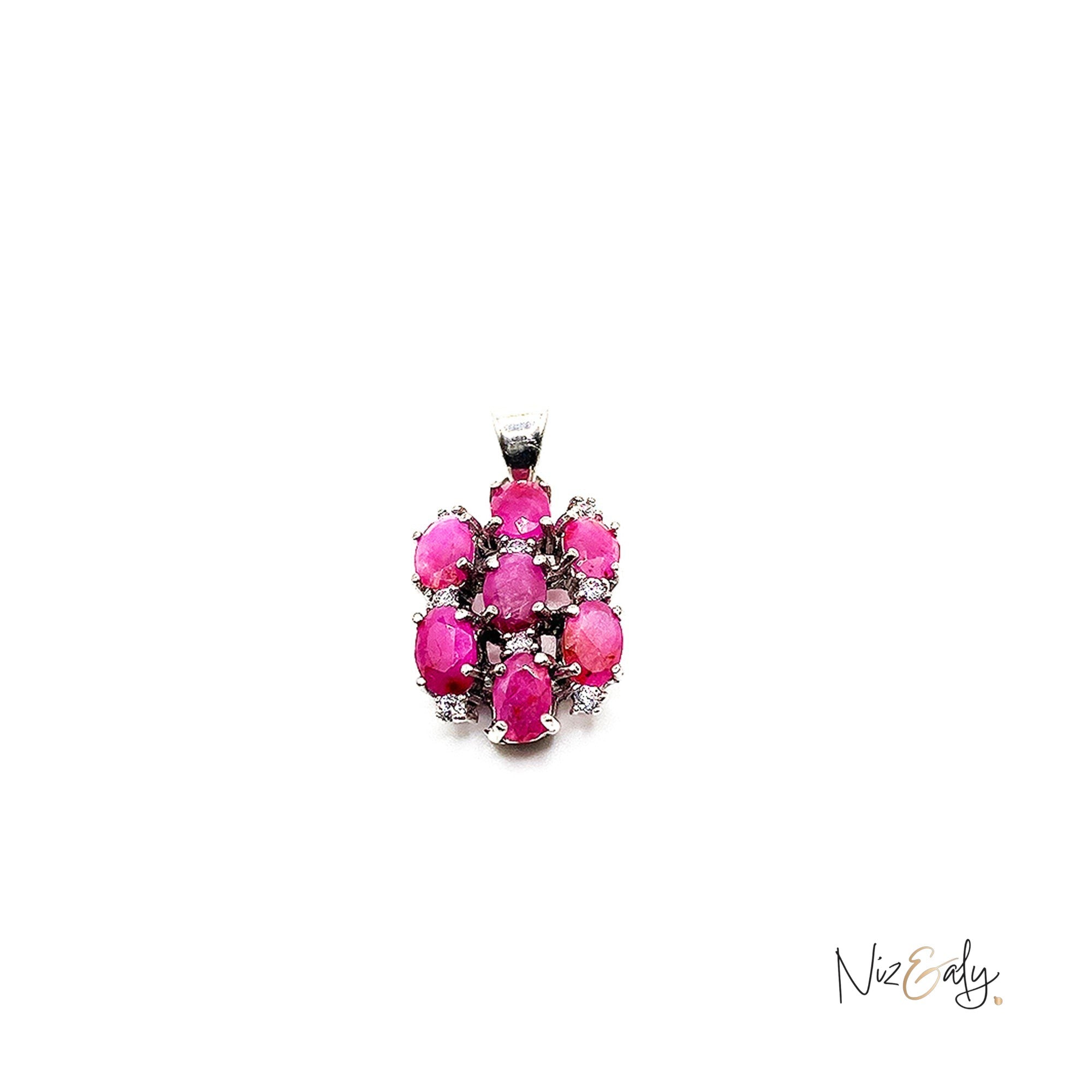 Niz & Aly cluster pendant featuring seven vibrant red rubies set in polished silver, creating a radiant floral design.