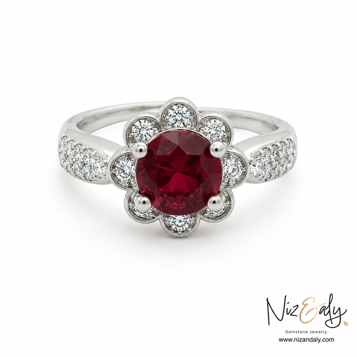 Niz & Aly floral-inspired ruby ring featuring a round crimson gemstone surrounded by diamond petals on a silver band.