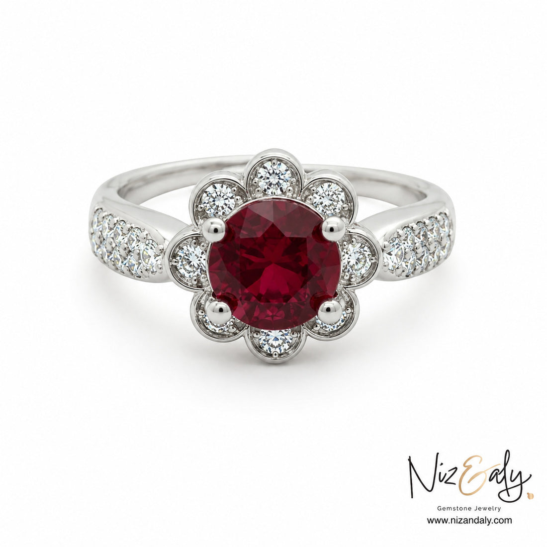 Niz & Aly floral-inspired ruby ring featuring a round crimson gemstone surrounded by diamond petals on a silver band.