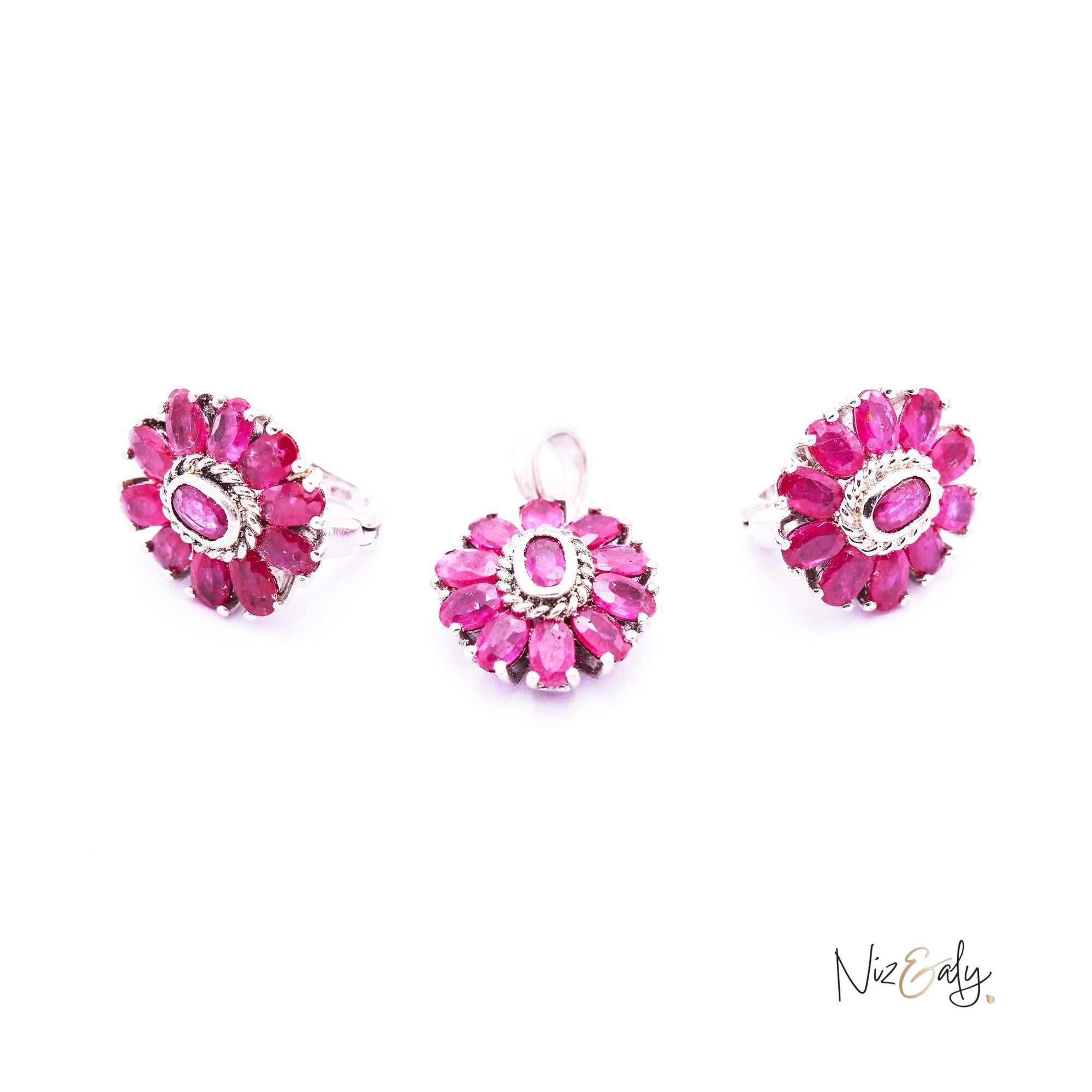 Niz & Aly Nothing But Rubies jewelry set featuring three floral-shaped pieces with deep red natural rubies.