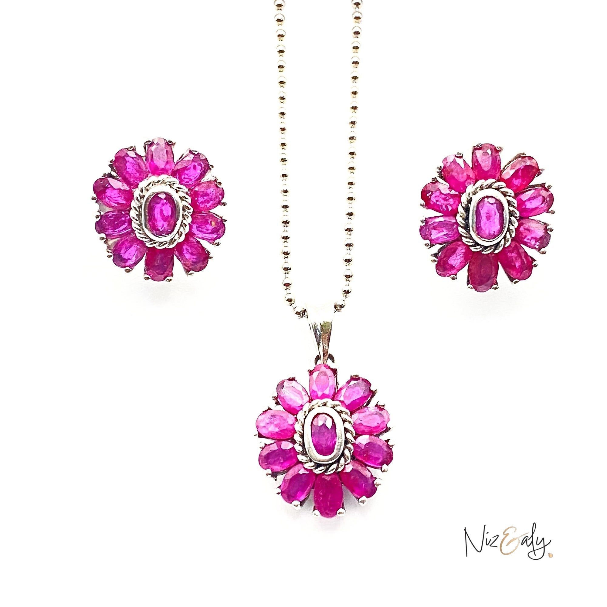 Niz & Aly Nothing But Rubies jewelry set featuring a floral pendant necklace and matching earrings with 33 rubies.