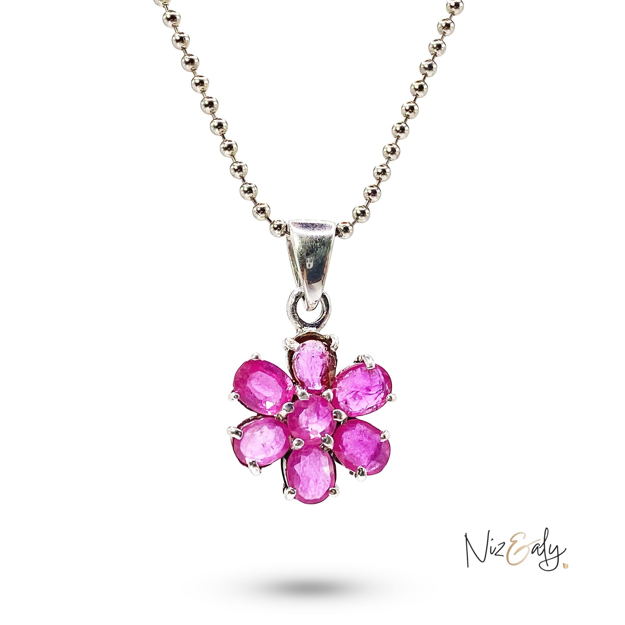 Niz & Aly ruby flower pendant featuring seven oval-cut vibrant red rubies set in a delicate floral arrangement