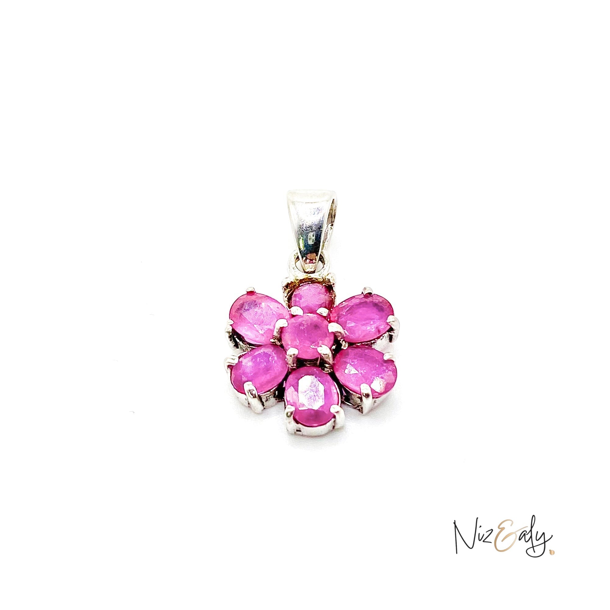 Niz & Aly ruby flower pendant featuring seven vibrant red rubies set in a delicate floral design on silver metal