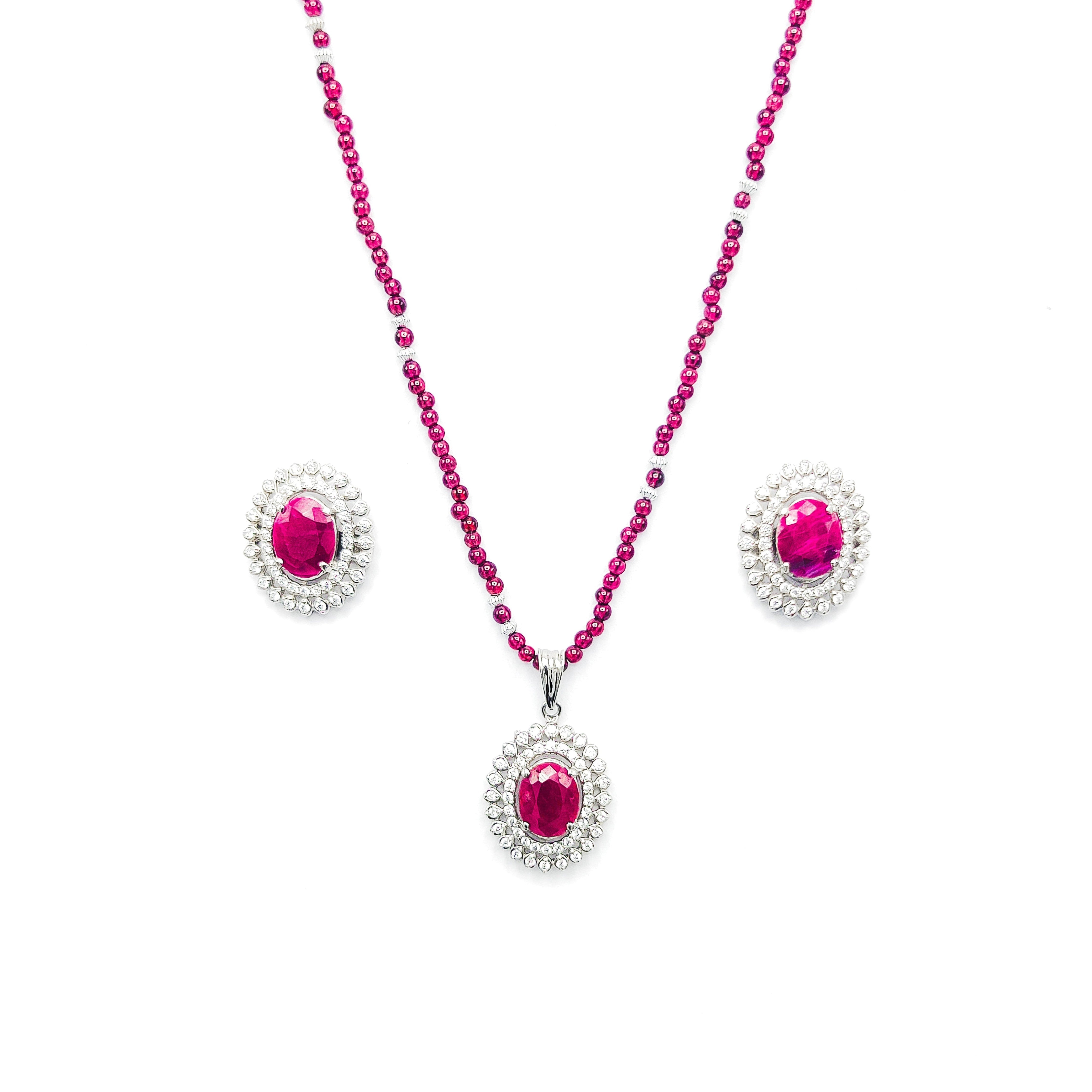 Niz & Aly African ruby pendant and earring set with a garnet bead necklace and diamond halo settings.