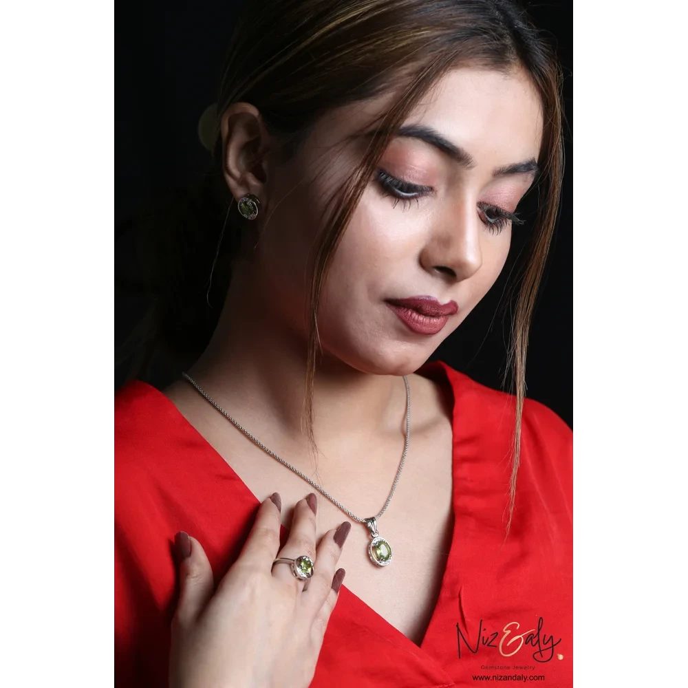 Niz & Aly Sage Dawn oval Arizona peridot pendant, ring, and earring set worn by a woman in a red top