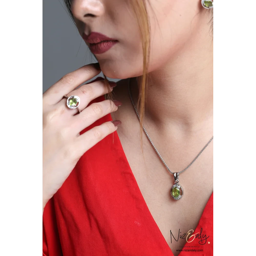 Niz & Aly Sage Dawn oval Arizona peridot pendant and ring set in silver worn by a model in a red top.