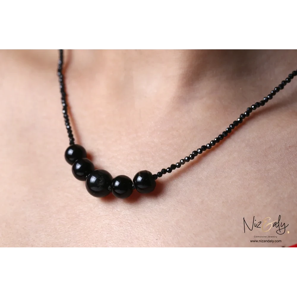 Niz & Aly dainty bar necklace featuring smooth black Shungite stones and faceted Onyx beads on a delicate chain.