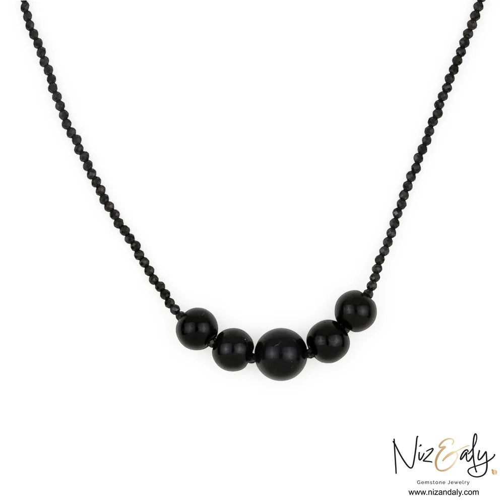 Niz & Aly dainty bar necklace featuring natural black Shungite stones and faceted Onyx beads on a delicate chain.