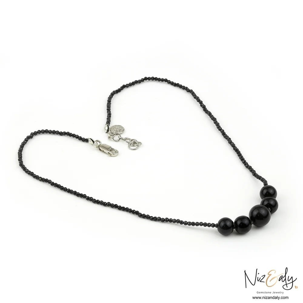 Niz & Aly dainty necklace featuring natural black Shungite stones, faceted Onyx beads, and a sterling silver clasp.