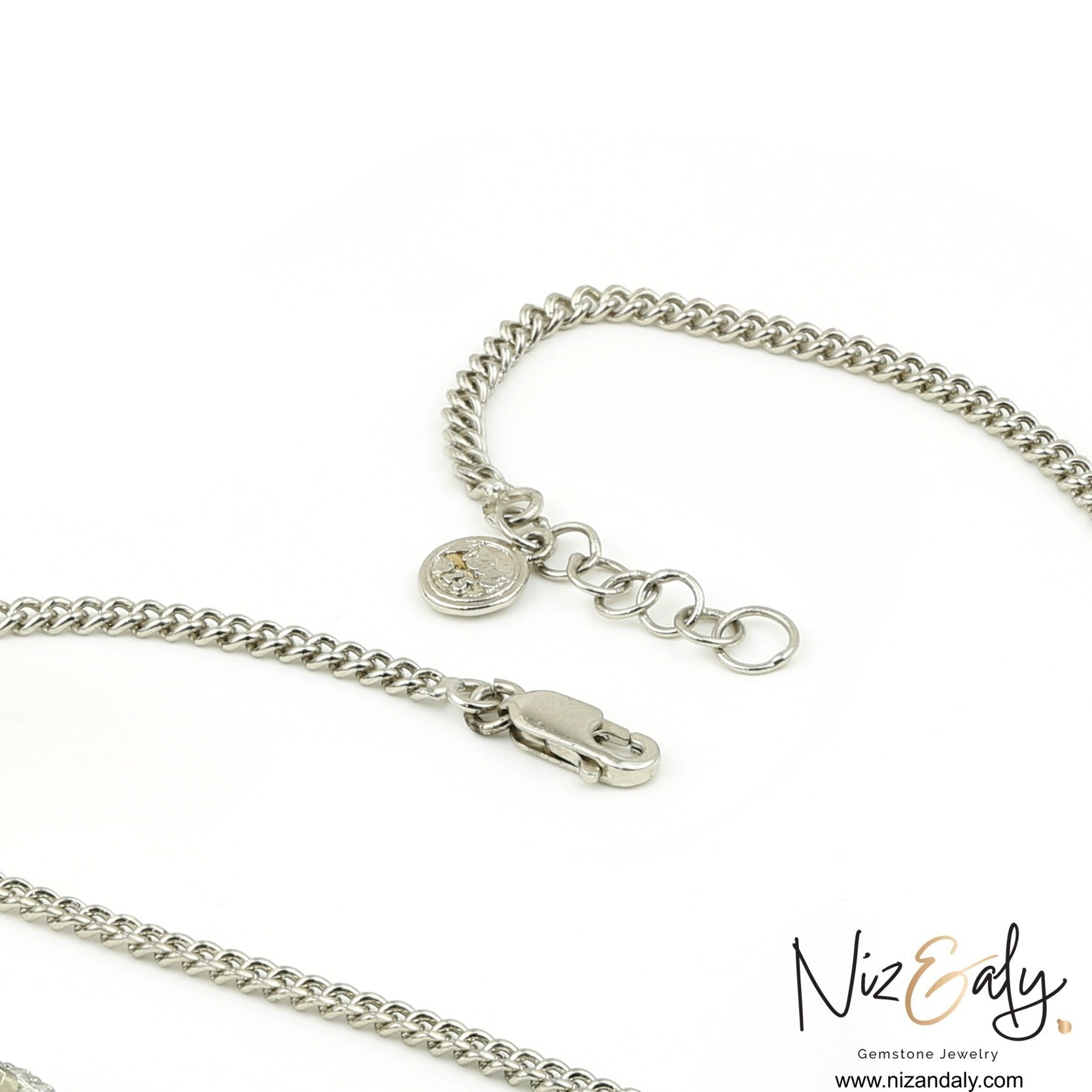 Niz & Aly silver chain necklace with a lobster clasp and branded charm on a white background