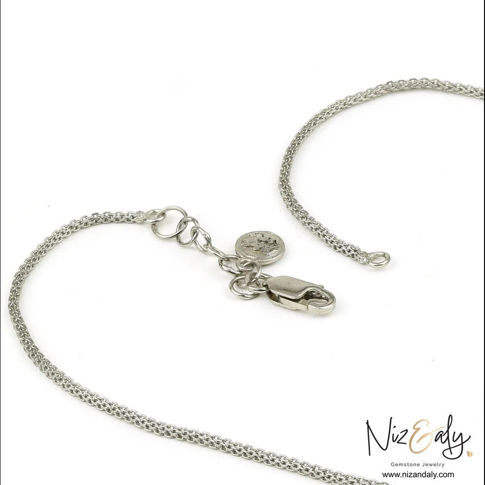 Niz & Aly silver necklace chain with lobster clasp and branded charm on a white background