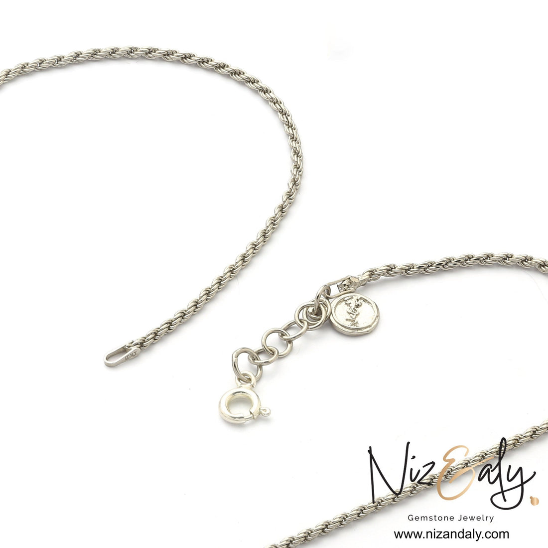 Niz & Aly silver rope chain necklace with a circular clasp and branded charm on a white background