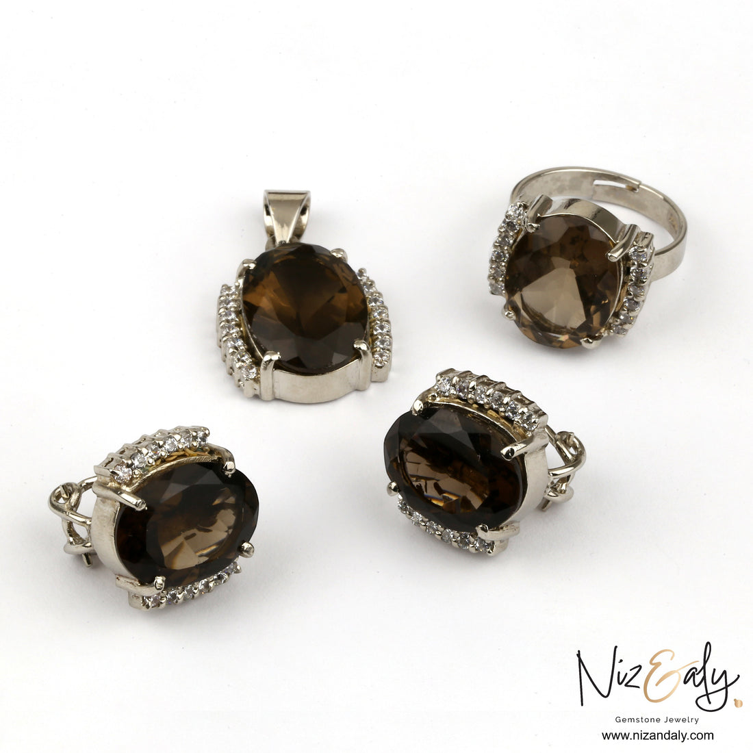 Niz & Aly smoky quartz jewelry set featuring a pendant, ring, and earrings with faceted brown gemstones and crystals.